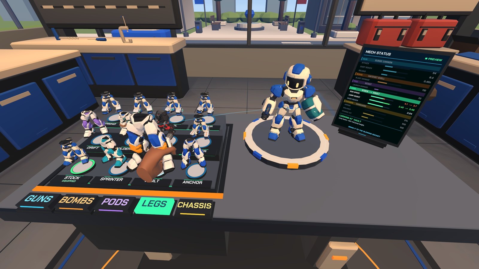 A hand holds robot legs over a parts deck next to a small mech on a turntable.
